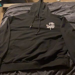 Black hoodie with white rose.